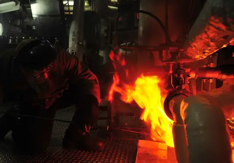 Lighting a burner on a ship's boiler