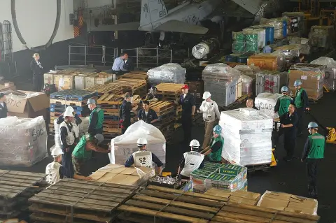 Pallets of provisions being taken on board